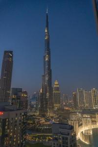 a view of a city skyline with a tall building at Downtown Oasis, Burj Khalifa Views, Luxury Amenities in Dubai