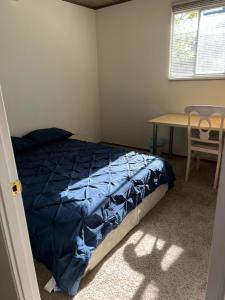 a bedroom with a bed and a table and a desk at Private rooms 2-1 in Sunnyvale