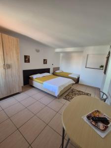a hotel room with a bed and a table at Vila Khalo in Mangalia