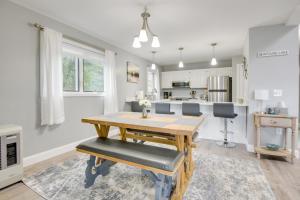 a kitchen and dining room with a wooden table and chairs at Newfound Lake Vacation Rental with Deck and Lake View in Bristol
