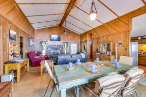 a dining room and living room with a table and chairs at Rural Arkansas Vacation Rental with Lake Access in Scranton