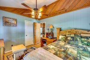 a bedroom with a bed and a ceiling fan at Rural Arkansas Vacation Rental with Lake Access in Scranton +22 photos