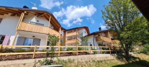 a house with a fence in front of it at Appartamento - Chalet Baltmann - Lavarone in Lavarone