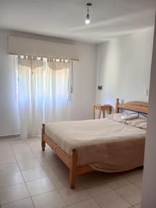 a bedroom with a bed and a window at Complejo DelfIn Gallo in Santa Rosa