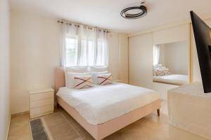 a bedroom with a large white bed and a mirror at The Yacht Apartment in Herzlia in Herzliyya B +20 photos