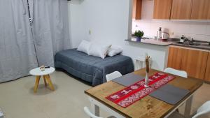 a small living room with a table and a couch at AeroDpto Centrico a minutos del Aeropuerto in Ezeiza
