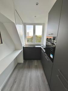 a kitchen with a staircase with a window in it at House Crocetta in Milan