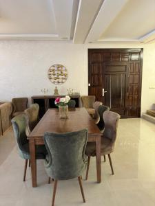 a dining room with a wooden table and chairs at Villa luxueuse Marrakech Ourika in Ourika