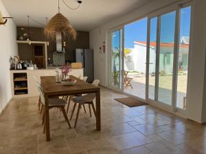 a kitchen and dining room with a table and chairs at B&B Casa Areia in Colares