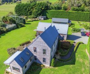 an aerial view of a house with a blue roof at Charming Spacious Rural Otaki Retreat in Otaki