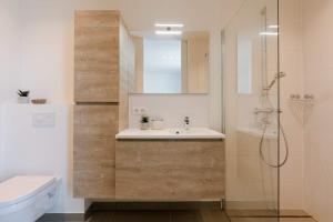a bathroom with a sink and a shower at Huswell - Spacious apartment in Ghent with big terrace in Ghent +22 photos