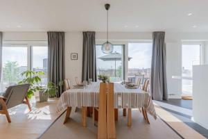 a dining room with a table and some chairs at Huswell - Spacious apartment in Ghent with big terrace in Ghent