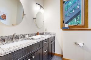 a bathroom with a sink and a mirror at Ferncrest Mountain House in Conway +43 photos