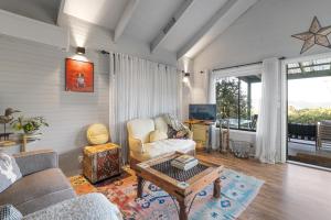 a living room with a couch and a table at Martha's Villa - Panoramic, Peaceful Location in Kangaroo Valley
