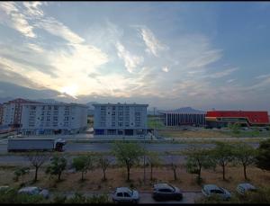 a city with buildings and cars parked in a parking lot at Obilex in Podgorica