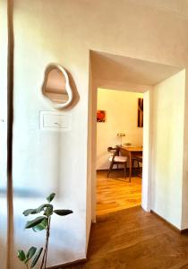 a room with a hallway with a table and a plant at Suite Atelier Arringo in Ascoli Piceno +22 photos