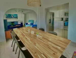 a wooden table in a kitchen with chairs around it at Blue Ocean Bungalow in Marathon