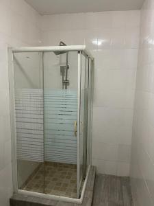 a shower stall with a glass door in a bathroom at Tao Connexus in Abuja
