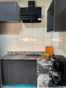 a kitchen with a counter top with a appliance on it at Tao Connexus in Abuja