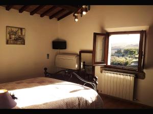 Postel nebo postele na pokoji v ubytování La Casina Toscana