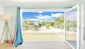 a room with a large window with a view at Oceanview, in Village, 20-steps to Path of Best Beach, Tiki-Bar, Free Bikes and Paddle-boards! in Siesta Key