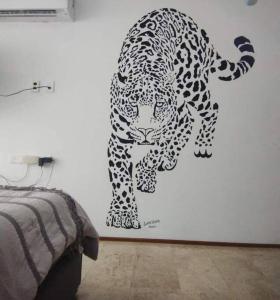 a stencil of a leopard on a wall at Depto ideal para tu viaje in Playa del Carmen +11 photos