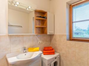 a bathroom with a sink and a washing machine at Blick ins Brixental in Hopfgarten im Brixental