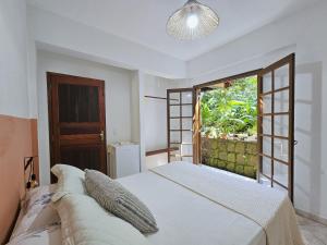 Postel nebo postele na pokoji v ubytování Guest House Prumirim