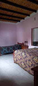 a bedroom with a bed and a mirror on the wall at Rancho Grande in Santa María