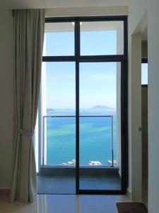 a view of the ocean from a window at The Shore Cozy Suite in CBD in Kota Kinabalu
