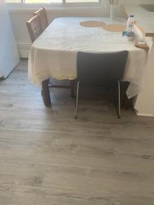 a table and chairs in a room with a floor at Montréal Steps Downtown Private Rooms in Montreal