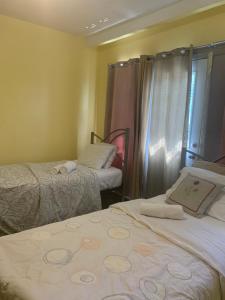 a hotel room with two beds and a window at Montréal Steps Downtown Private Rooms in Montreal