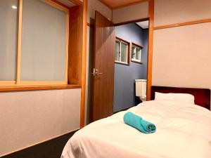 Postel nebo postele na pokoji v ubytování Ember Lodge - Hakuba