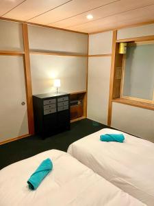Postel nebo postele na pokoji v ubytování Ember Lodge - Hakuba