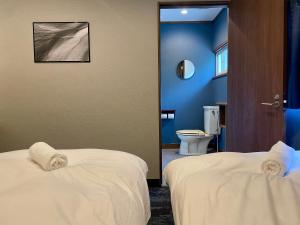 Postel nebo postele na pokoji v ubytování Ember Lodge - Hakuba