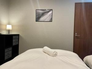 Postel nebo postele na pokoji v ubytování Ember Lodge - Hakuba