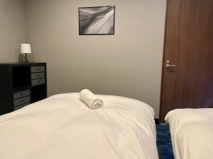 Postel nebo postele na pokoji v ubytování Ember Lodge - Hakuba