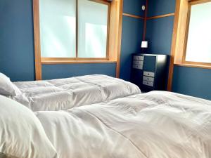 Postel nebo postele na pokoji v ubytování Ember Lodge - Hakuba