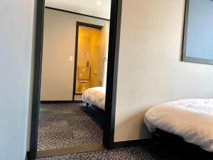 Postel nebo postele na pokoji v ubytování Ember Lodge - Hakuba