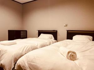 Postel nebo postele na pokoji v ubytování Ember Lodge - Hakuba