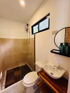 a bathroom with a toilet and a shower and a sink at Lolas Villa El Nido in El Nido +13 photos