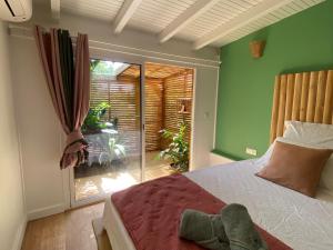Postel nebo postele na pokoji v ubytování Villa bleu karaïbes