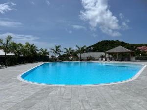 a large blue swimming pool with a gazebo at Appartement Sunrise in Cul de Sac