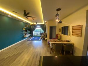 a living room with a ceiling fan and a dining room at RHFL Homestay Putrajaya in Putrajaya