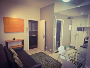 a living room with a couch and a table at Small quiet condo posto 6 in Rio de Janeiro