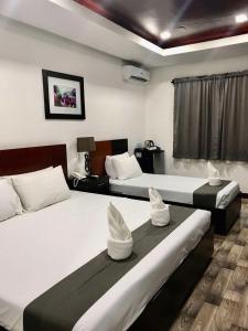 Postel nebo postele na pokoji v ubytování Hotel Gabriella