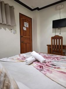 Postel nebo postele na pokoji v ubytování Citrine Tourist Inn