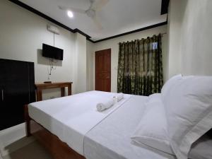 Postel nebo postele na pokoji v ubytování Citrine Tourist Inn