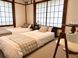 Postel nebo postele na pokoji v ubytování 湯沢雪の宿 YUZAWA Snow Inn-Ski IN Ski OUT
