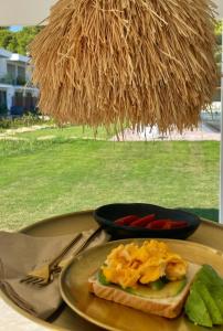 a plate of food on a table with a plate of food at Oikos Sani Suites in Sani Beach